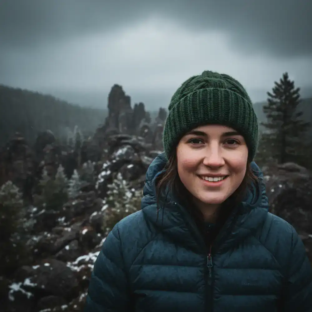 Portrait of a female hiker wearing a beanie and looking at the camera