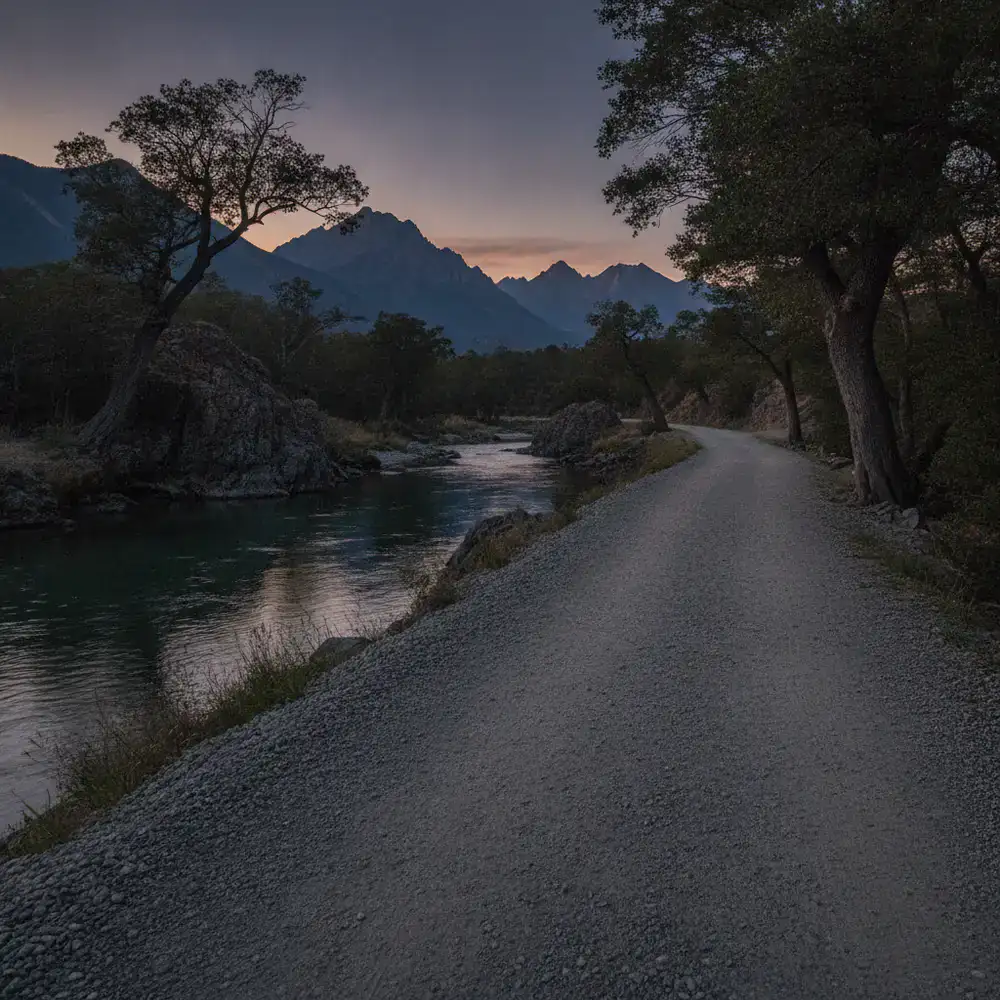 Smooth gravel trail running alongside a calm river